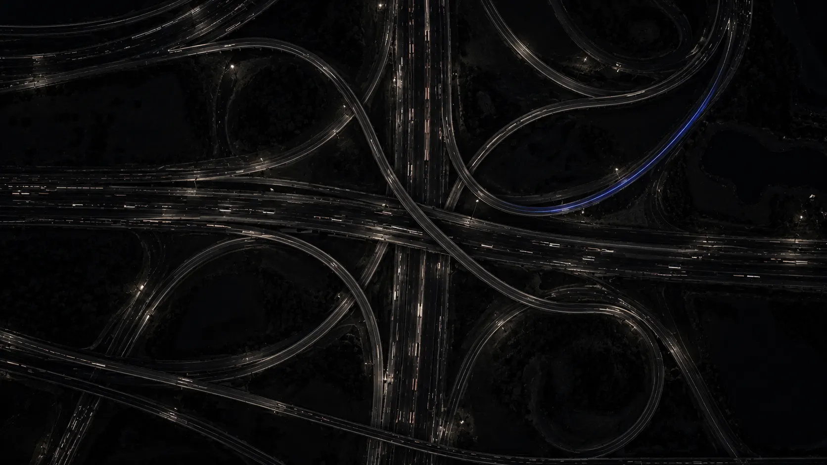 Overhead view of a highway interchange at night