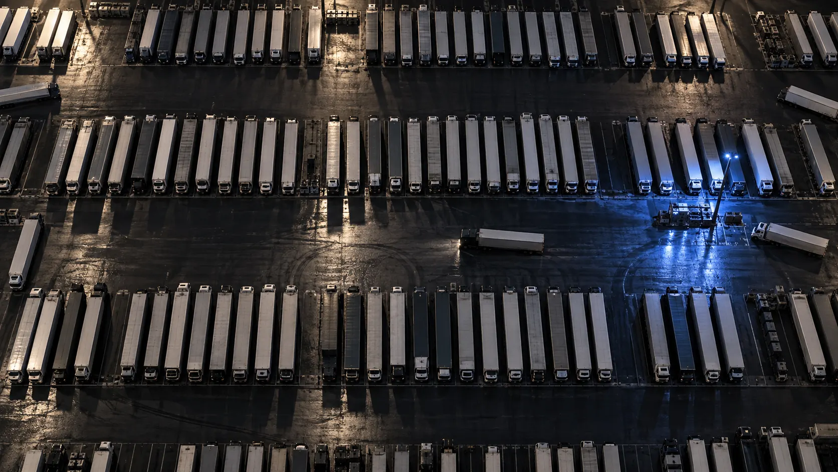 Aerial view of rows of trailers in a truck yard at dusk